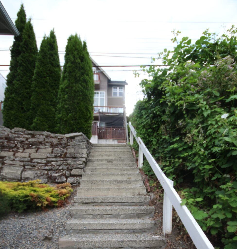 An allegedly haunted set of stairs with a white railing to the side