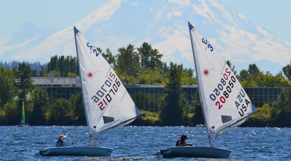 Two Regattas float side-by-side on the water with Mount Tahoma in the background