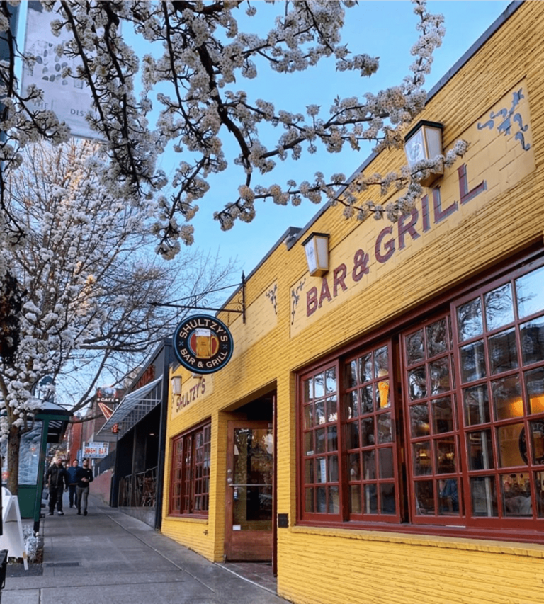 Exterior shot of Scultzy's Bar & Grill during spring with cherry blossom trees