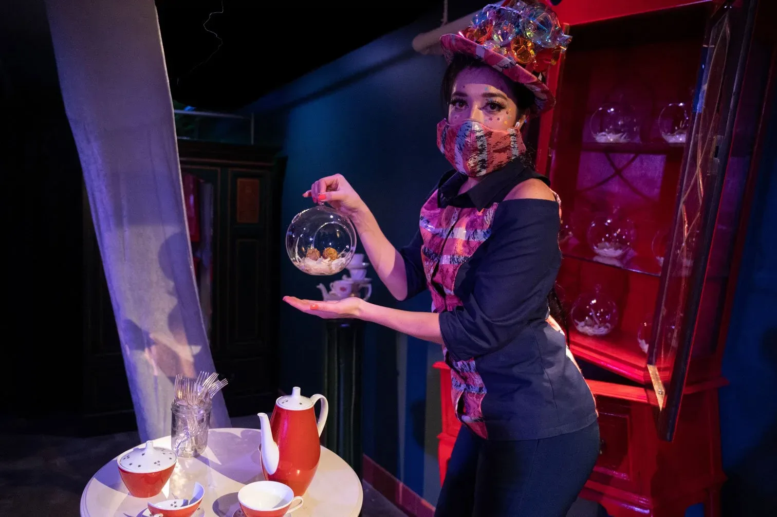A performer pours tea at Cafe Nordo's Down the Rabbit Hole
