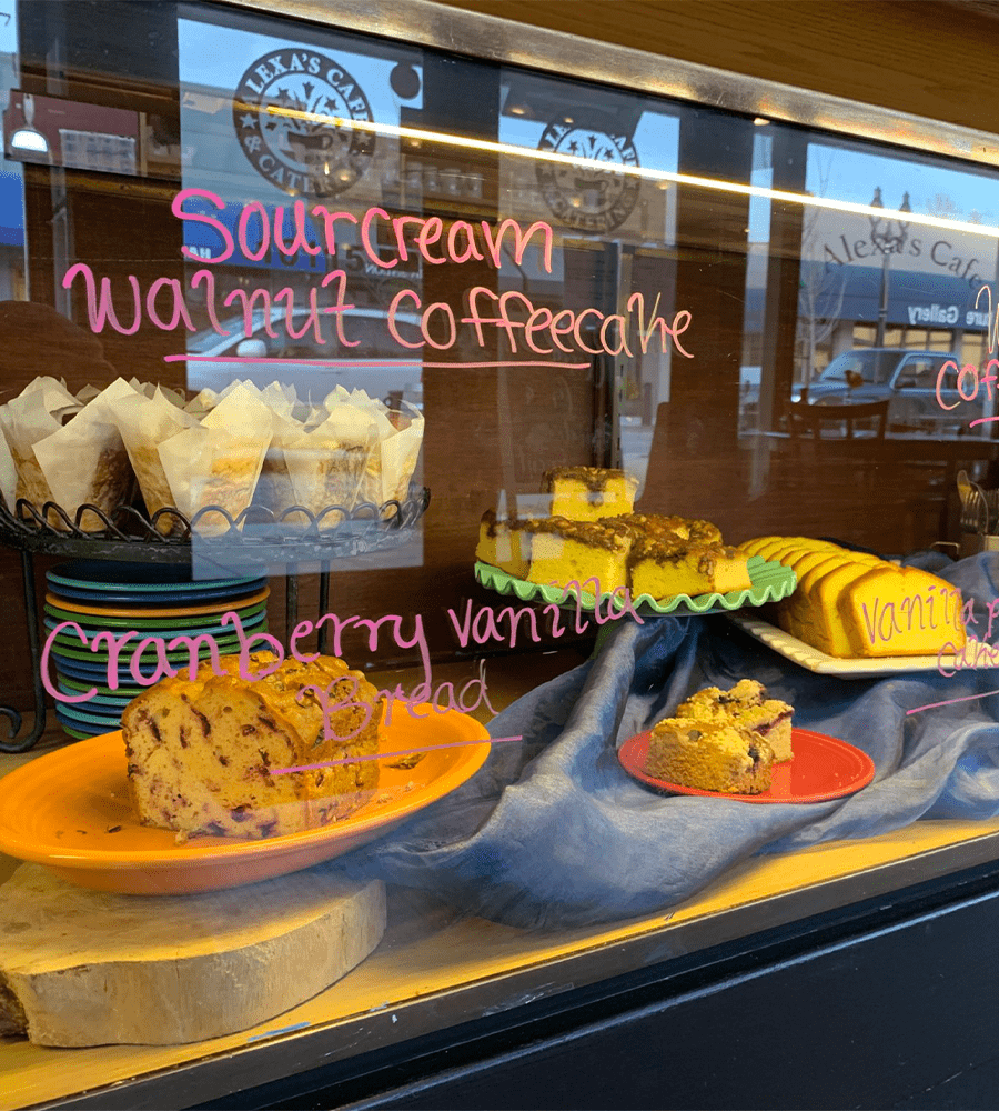 A spread of baked goods behind glass