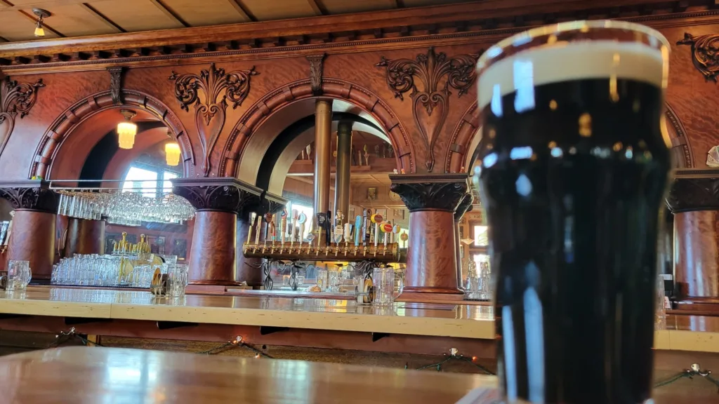 Picture of a dark beer on a counter inside Beveridge Place Pub