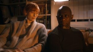 Tilda Swinton and Idris Elba look at each other in a still from Three Thousand Years of Longing. Elba wears elf ears.
