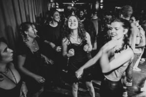 Group of women dancing and smiling at Motown on Mondays