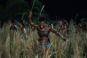 A still from the movie, The Woman King. Nanisca, played by Viola Davis, leads the Agojie warriors in a battle formation