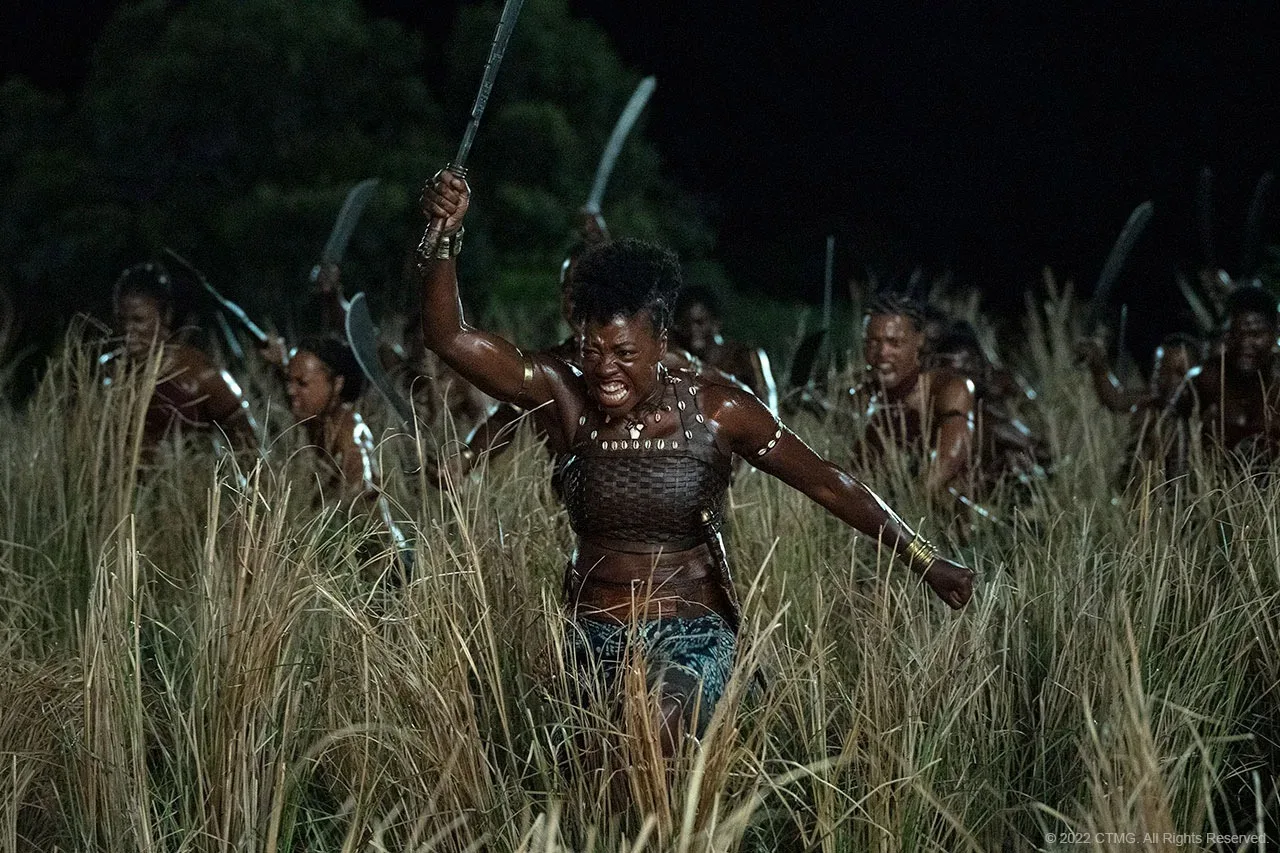 A still from the movie, The Woman King. Nanisca, played by Viola Davis, leads the Agojie warriors in a battle formation