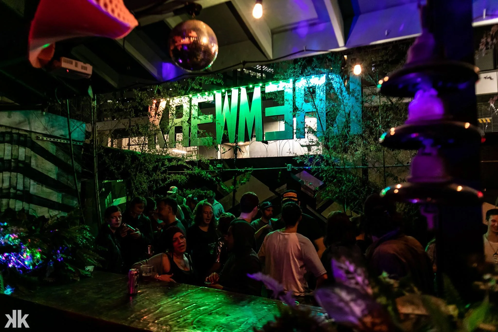 the patio of kremwerk with a lit-up sign