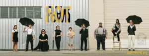 The cast of Not / Our Town pose in a line