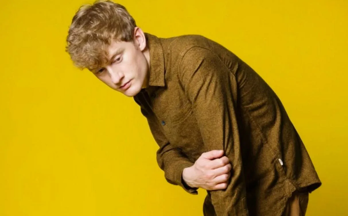 James Acaster against a bright yellow background