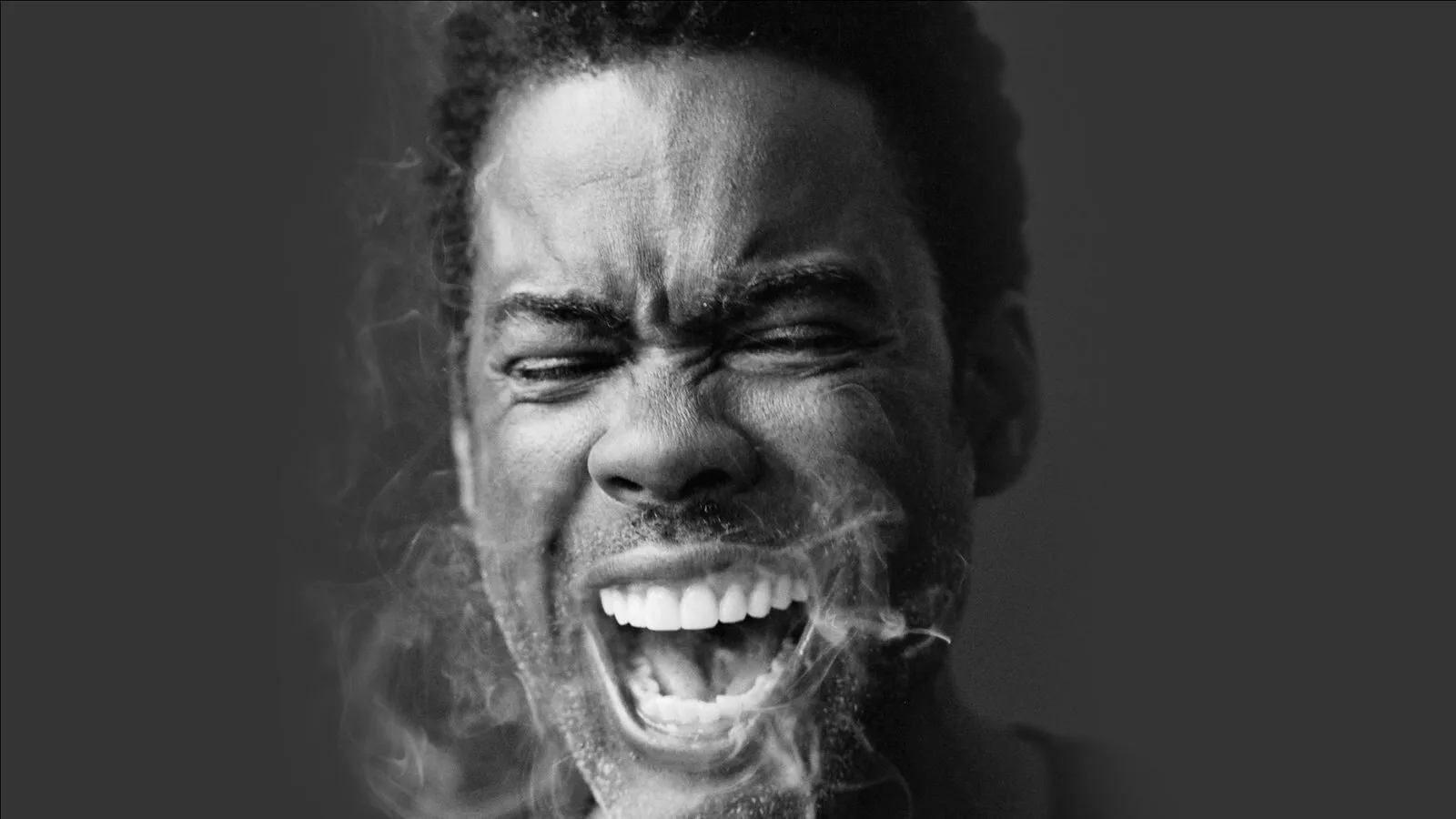 A promotional photo for Chris Rock's current tour, featuring a photo of Chris Rock with smoke coming out of his mouth