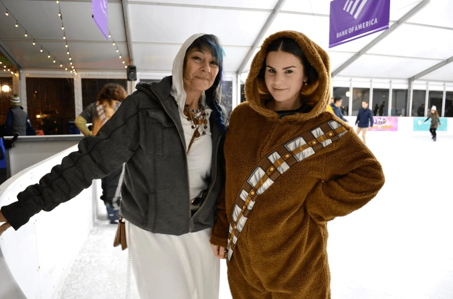 Two skaters in costumes pose at the Bellevue Downtown Ice Rink