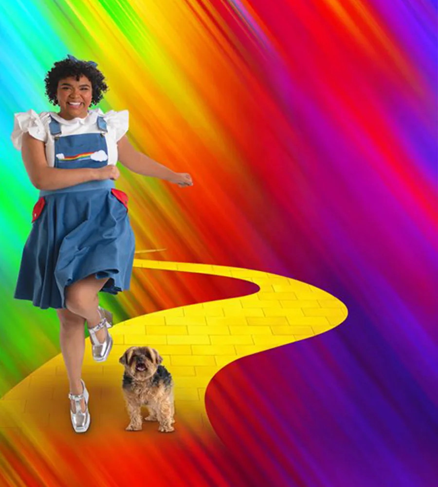 A rainbow-colored poster for The Wiz, with Dorothy and Toto walking on the yellow-brick road.