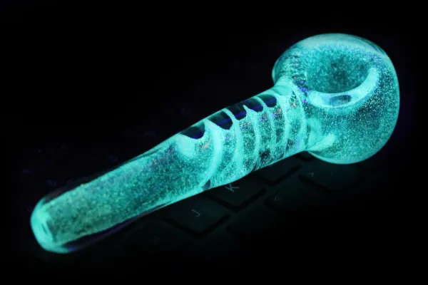 A thick inside-out glow-in-the-dark frost pipe with a twist inside the stem.