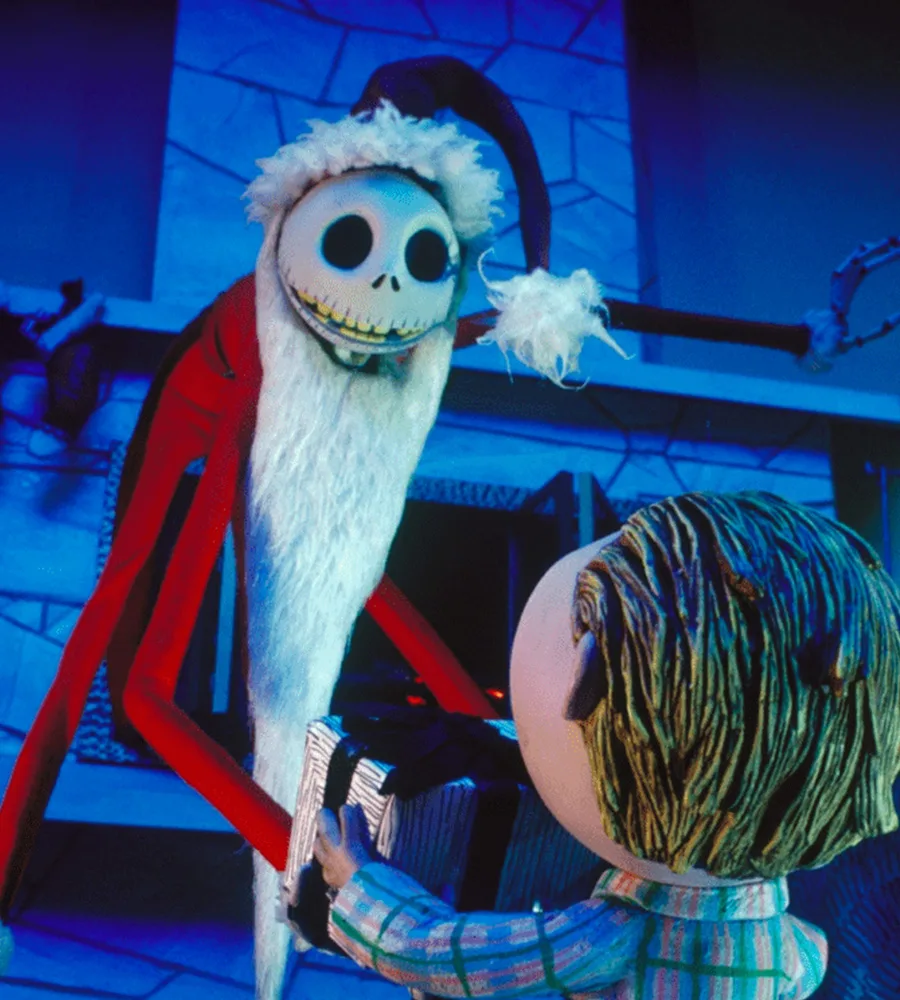 Jack Skellington dressed as Santa Claus gives a present to a small child