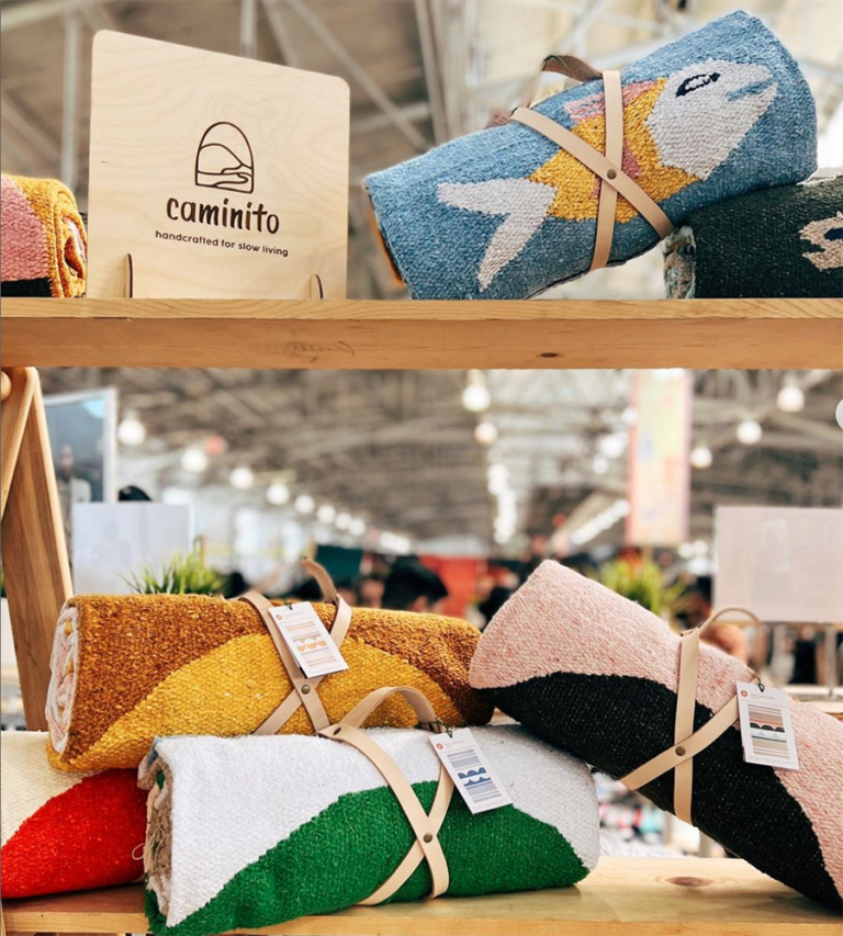 A display stand of a few of Caminito's colorful blankets.