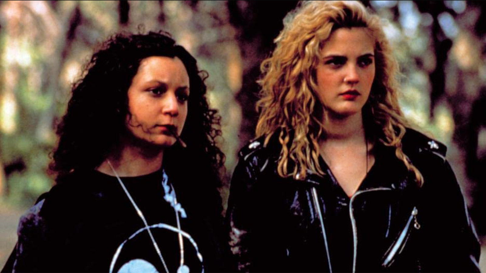 A screencap from Poison Ivy. The characters Ivy and Sylvie stand together, looking at something offscreen