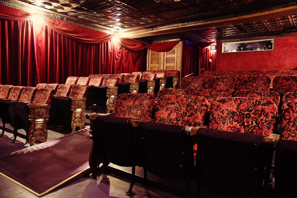 A row of soft, plush movie theater chairs inside of The Grand Illusion in the U District in Seattle.