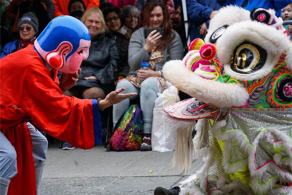 Two performers from LQ Lion Dance perform at a Lunar New Year celebration at Wing Luke Museum in the Chinatown-International District