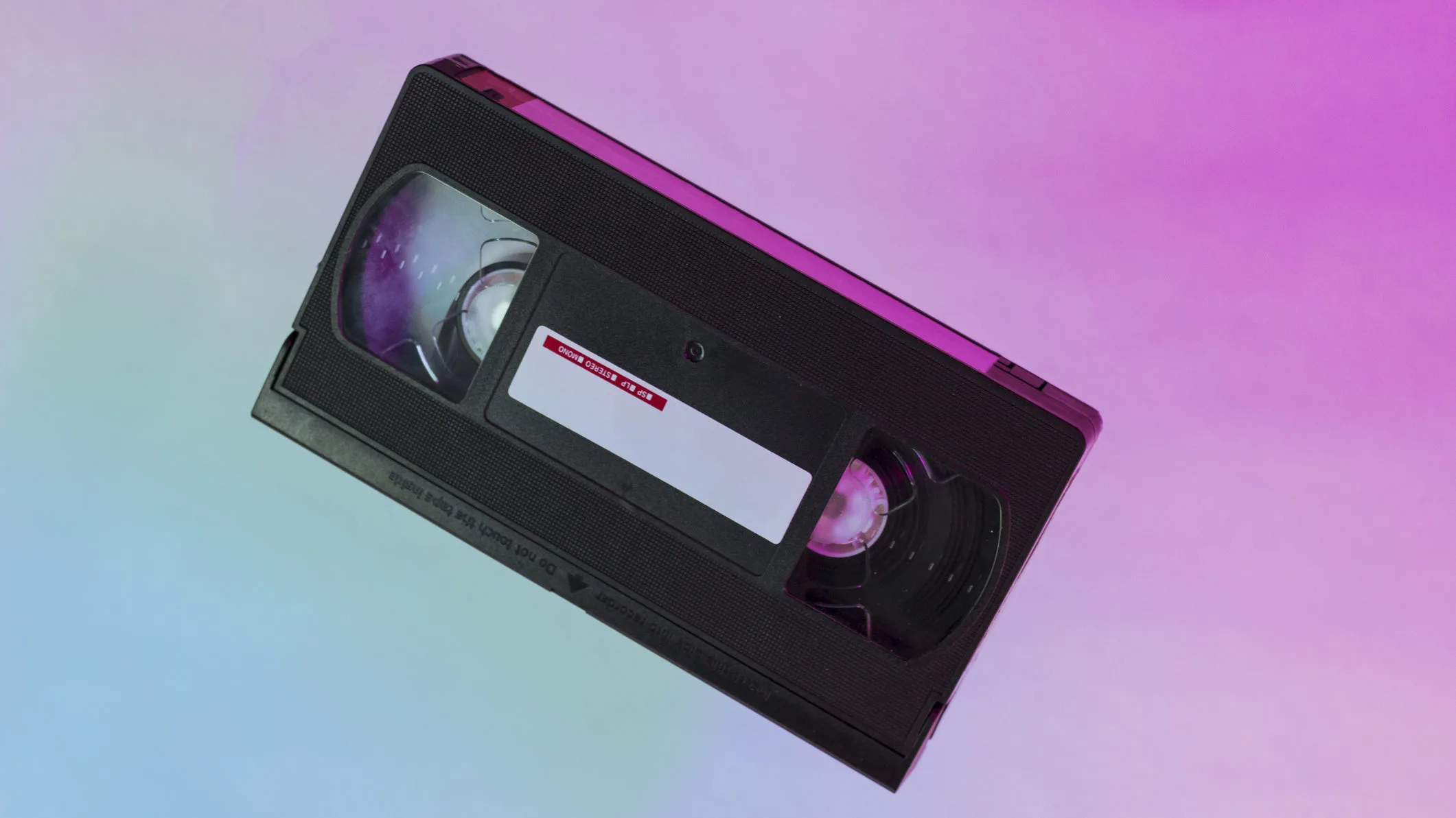 Diagonal video tape on blue-pink gradient background