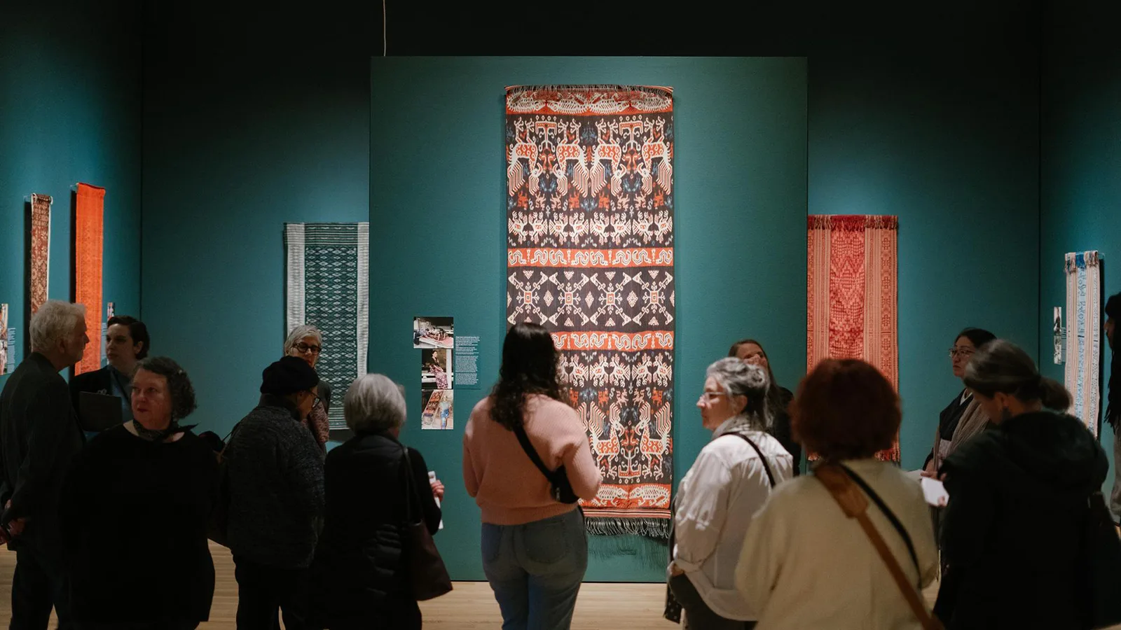 A crowd gathers for the Ikat press preview tour with curator Pam McClusky on March 7 2023 at Seattle Art Museum.