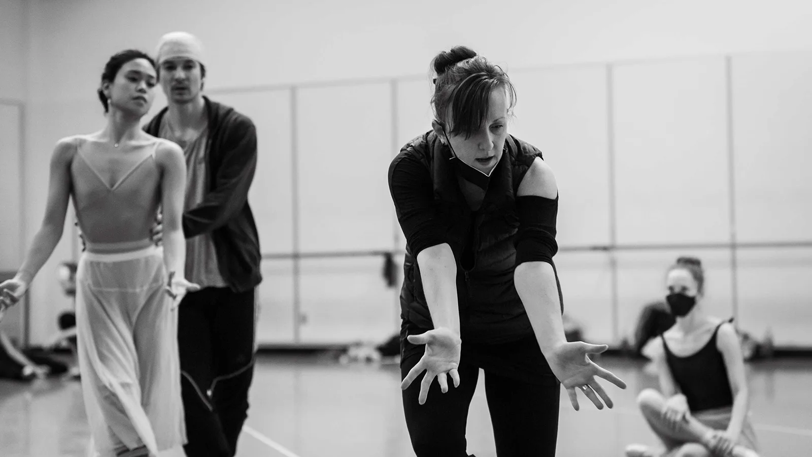 Choreographer Jessica Lang works with Angelica Generosa and James Yoichi Moore in a Pacific Northwest Ballet studio. The photo is in black and white.