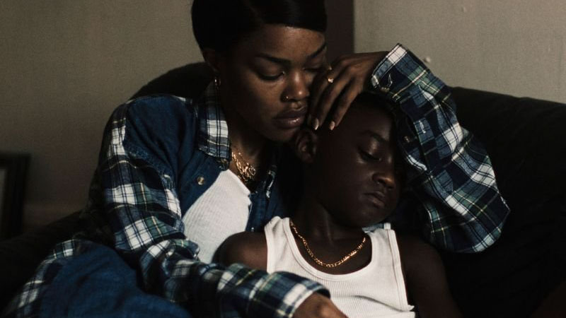 A screencap from A Thousand and One. Inez (Teyana Taylor) holds her son, Terry (Aaron Kingsley Adetola) in a supportive embrace.