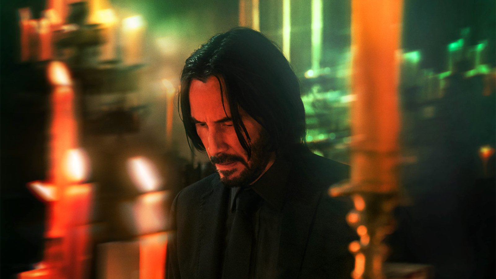 A screenshot from John Wick 2. He is surrounded by candles in a church