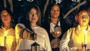 A promo image for the production of Our Dear Dead Drug Lord featuring four teen girls holding lanterns and looking directly at the camera
