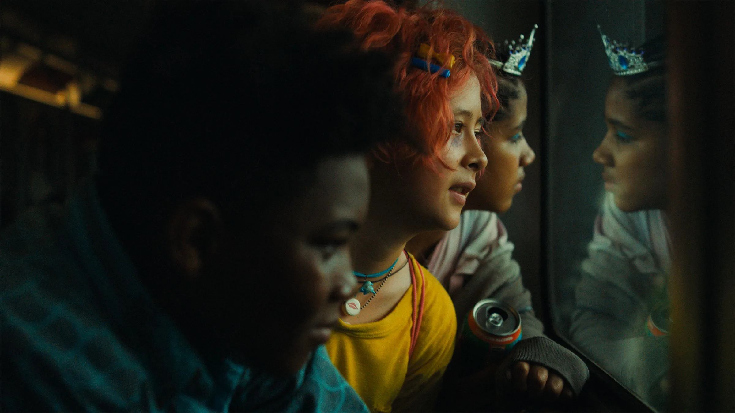 A still from the feature "Short." Three children look at something through glass