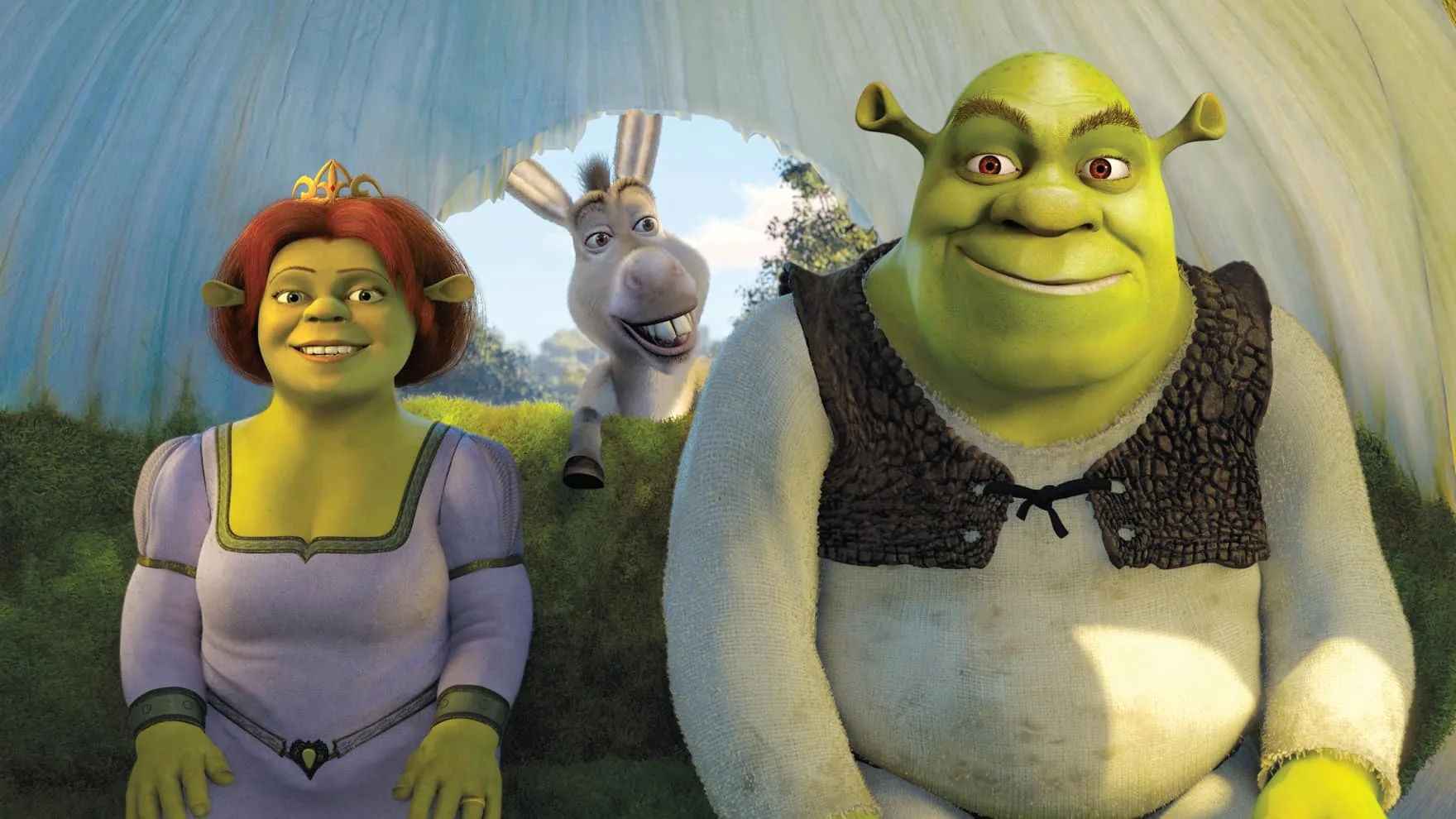 Shrek and Fiona sit in their onion carriage with Donkey in the background