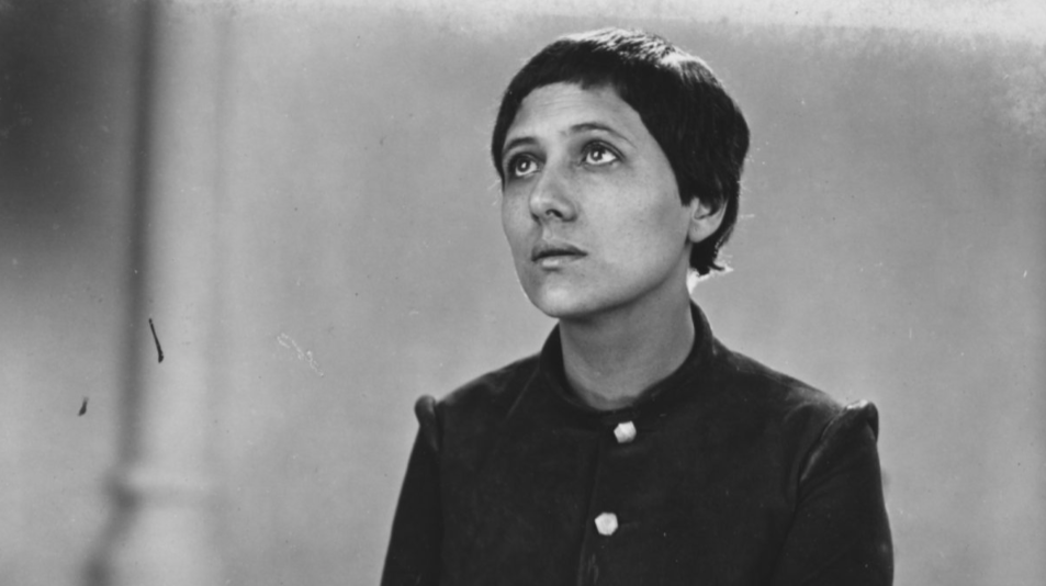 Joan of Arc looks up in a thoughtful black and white still from Passion of Joan of Arc