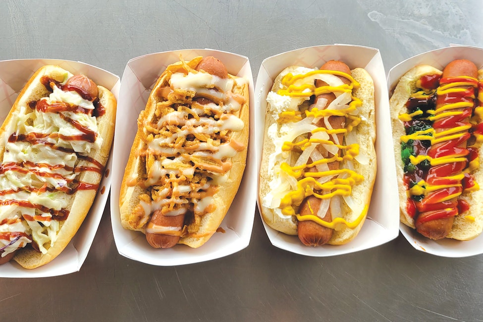A row of hotdogs with lots of fillings