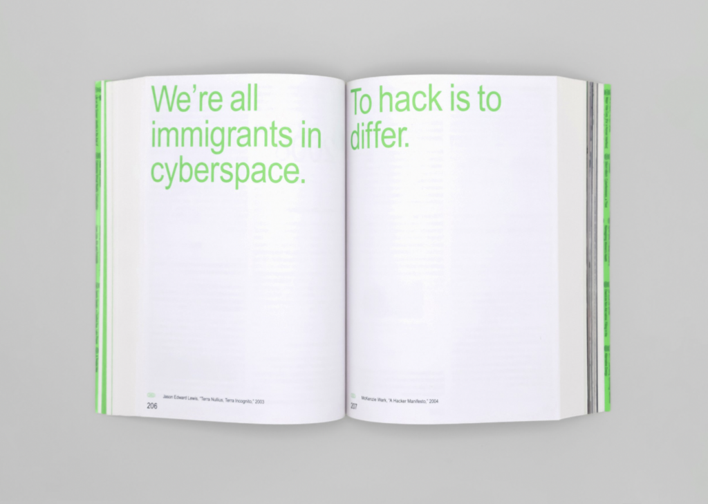 A book is open with lime green letters that read "We're all immigrants in cyberspace. To hack is to differ."