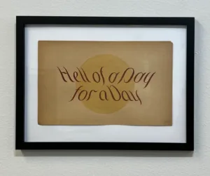 A framed painting that reads "Hell of a Day for a Day"