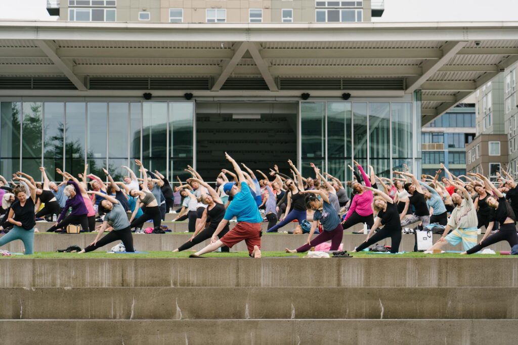 A group of people doing yoga at Summer at SAM at the Olympic Sculpture Park