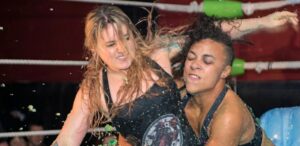 Two wrestlers fight in a pool of jello