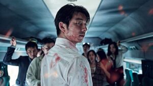 Train to Busan still featuring a bloodied man turning around on a train.