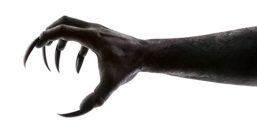 A hand with long, scary nails reaches out