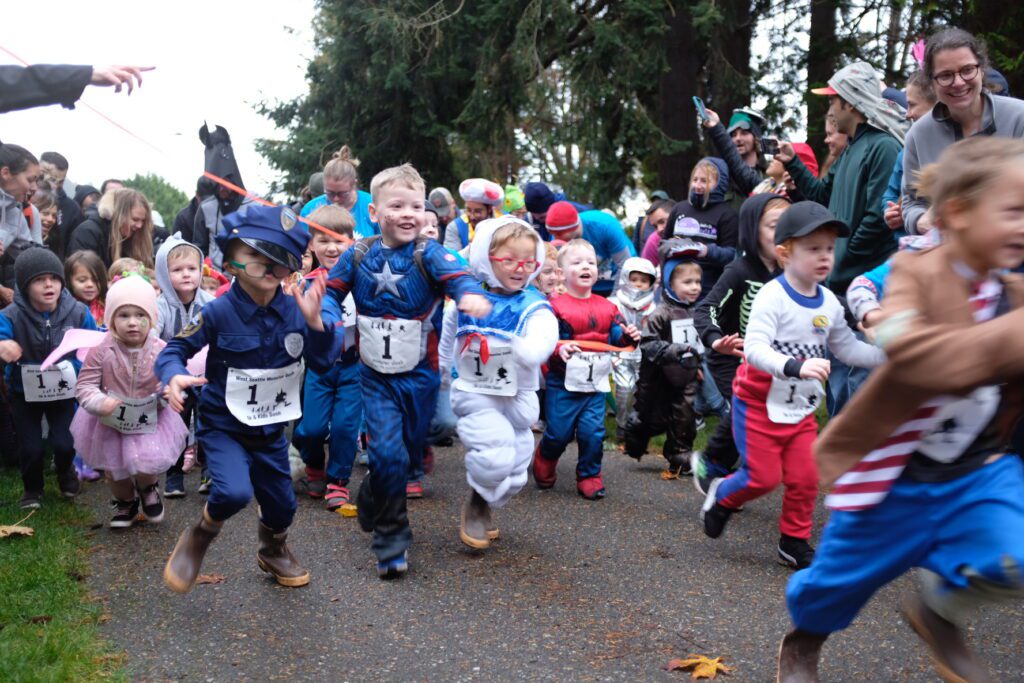 A group of kids run during the West Seattle Monster Dash