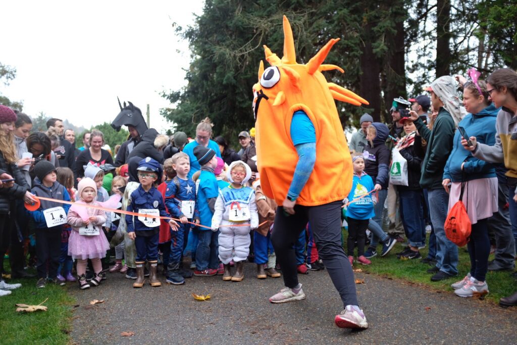 A group of children line up to run in a costume fun run.