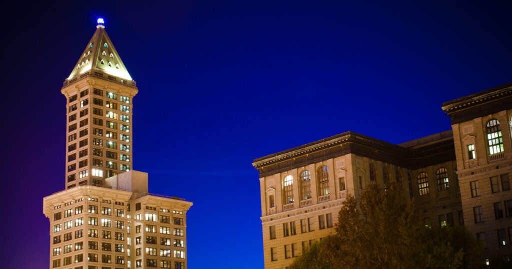 Historic Smith Tower and King County District Court in downtown Seattle, WA at night.