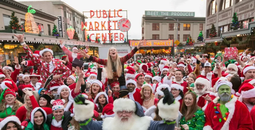A very large group of people dressed as Santa standing in front of the Pike Place Market sign.