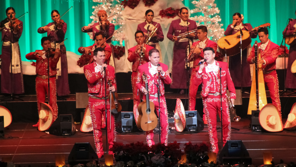 A performance of Jose Hernandez' Merry-Achi Christmas with Mariachi Sol de Mexico dressed in red.