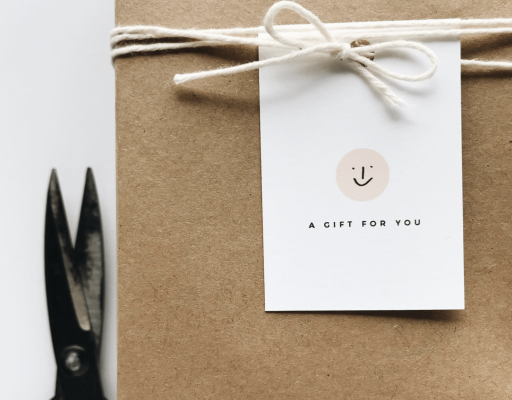 Stationary from Euni + Co featuring a paper-wrapped gift and a gift card that reads "a gift for you."