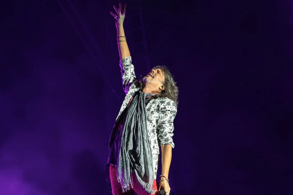 A lead performer for the band Foreigner raises a fist in the air in this promotional image for the Washington State Fair 2024