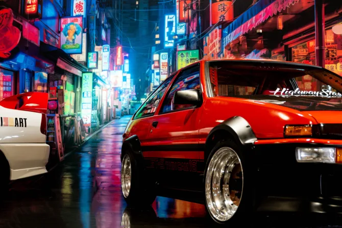 A shot of two cars from the Shinka exhibit against a nightime Japanese cityscape.