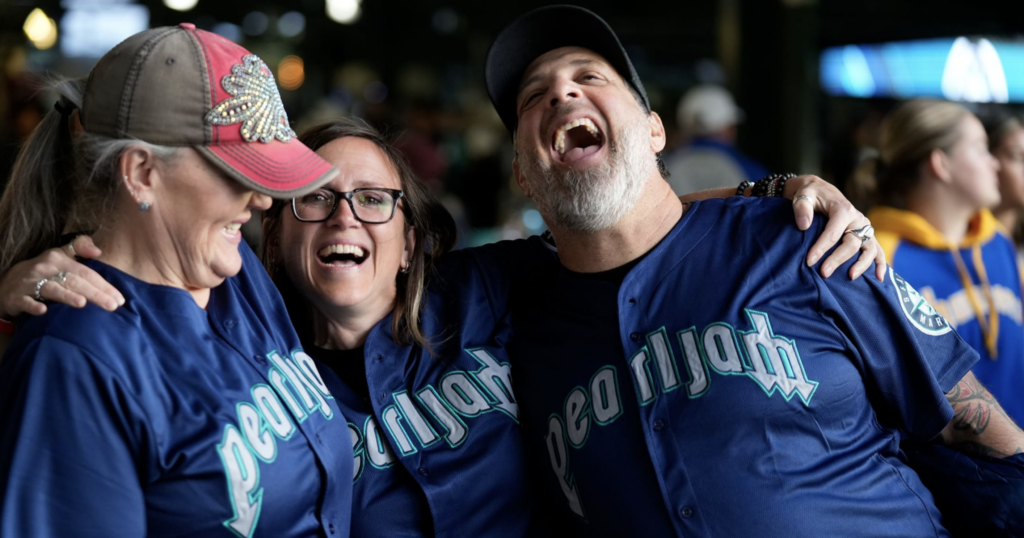 A group of people in Pearl Jam Mariners jerseys.