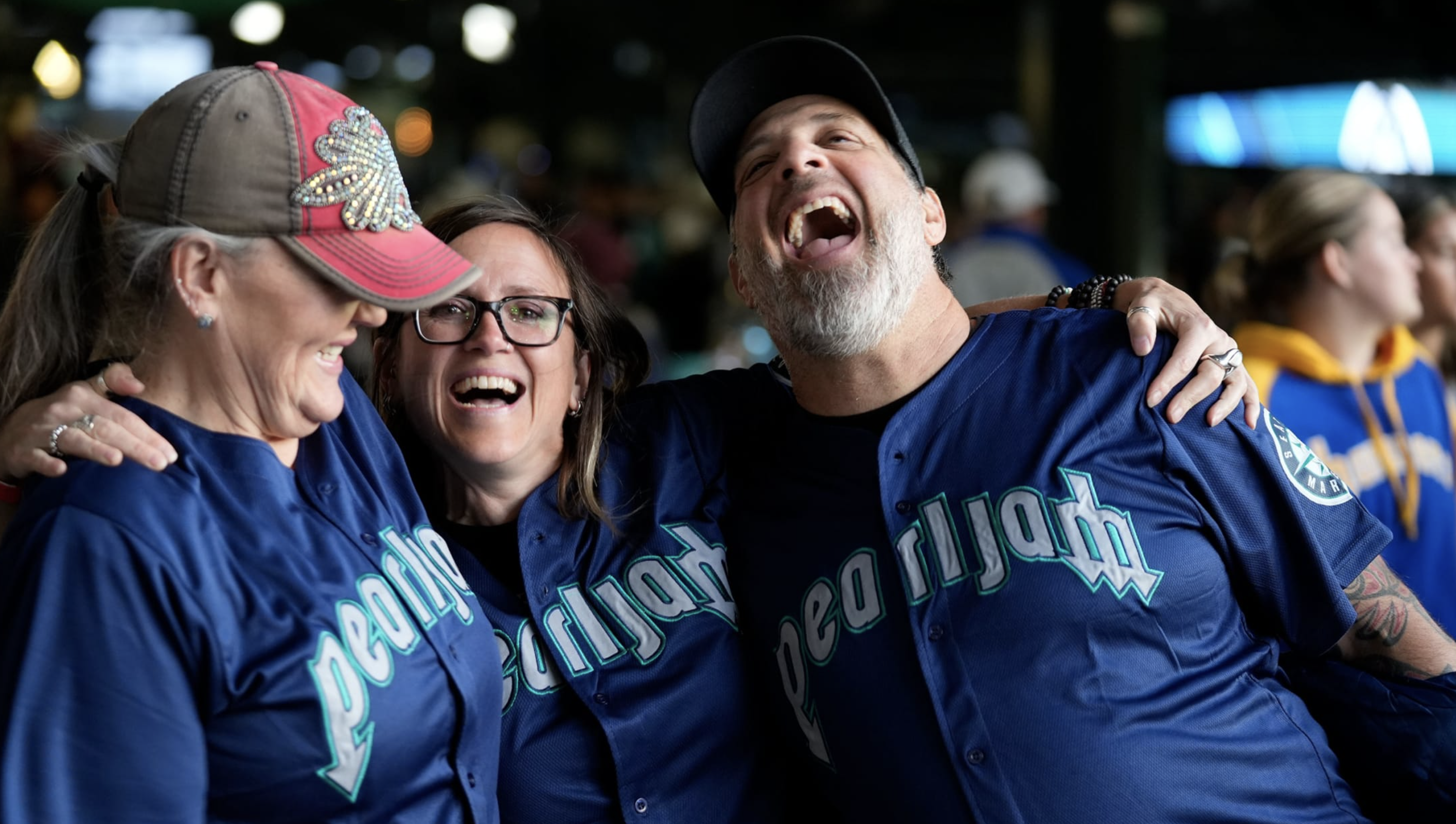 A group of people in Pearl Jam Mariners jerseys.
