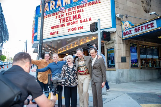 The cast of Thelma poses under the marquee at Paramount during the opening night of SIFF 2024.