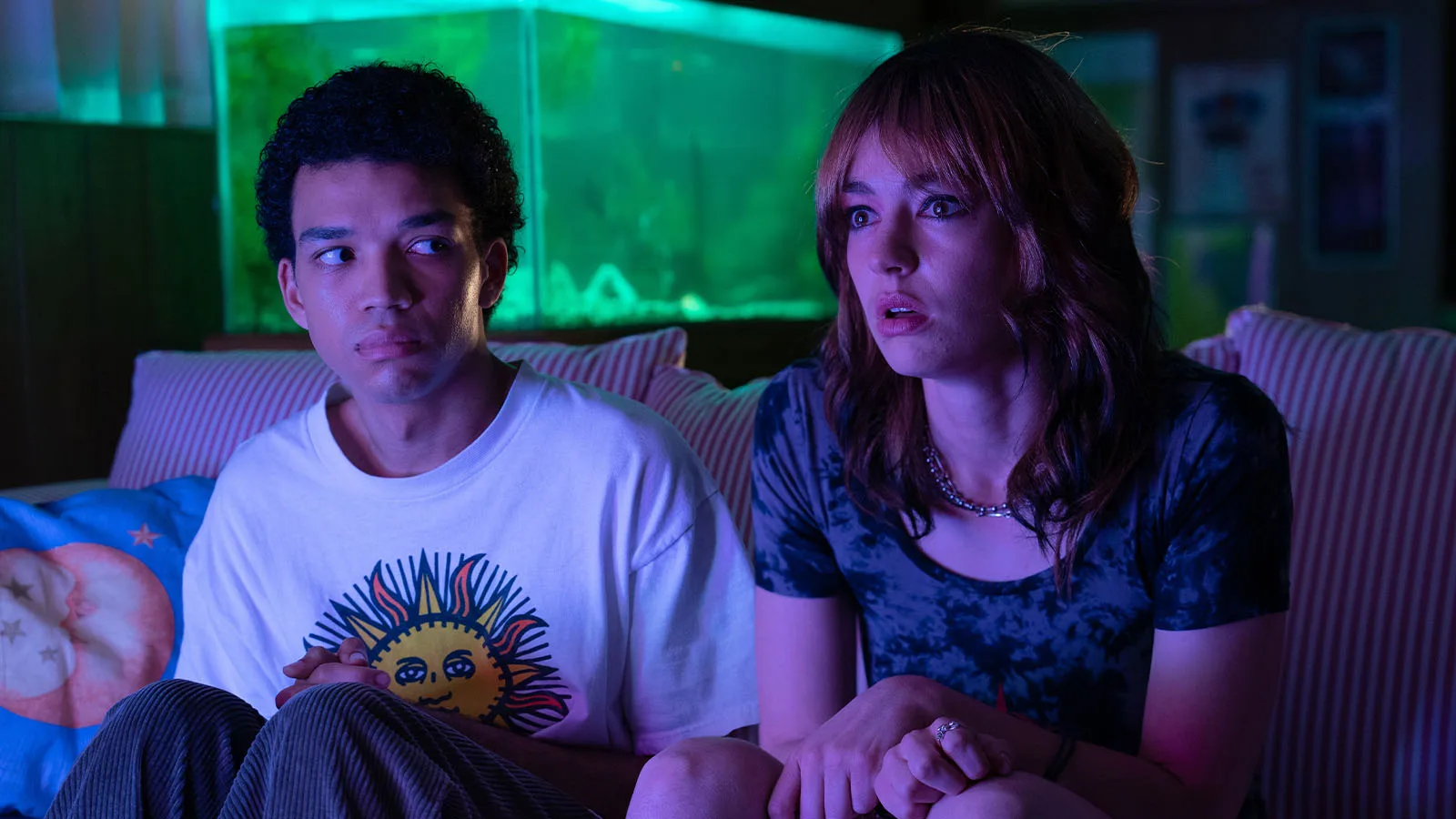 Two friends stare at a glowing TV screen in this promotional still for I Saw the TV Glow.